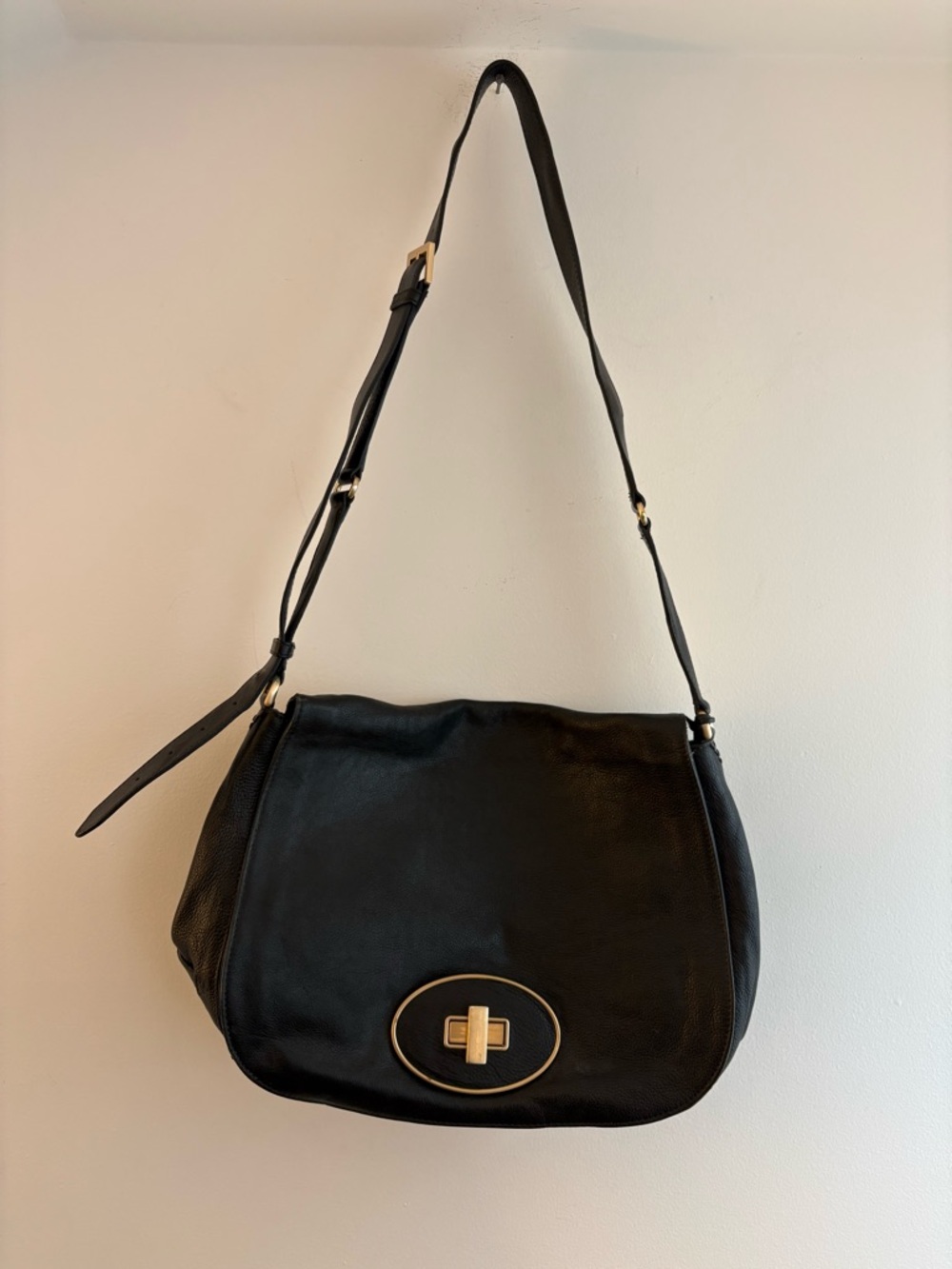 Cole Haan black leather messenger bag with gold hardware